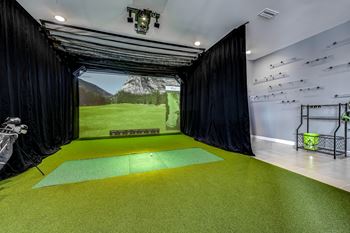 A room with a green floor and a black curtain on the side at Ironwood Flats Apartments, Brandon