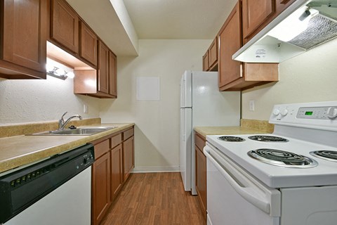 a kitchen with white appliances and wooden cabinets