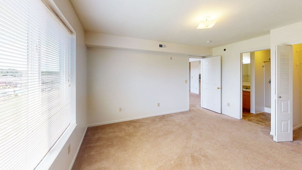Large master bedroom with a walk-in closet and attached bathroom at Limestone Creek Apartment Homes, Alabama