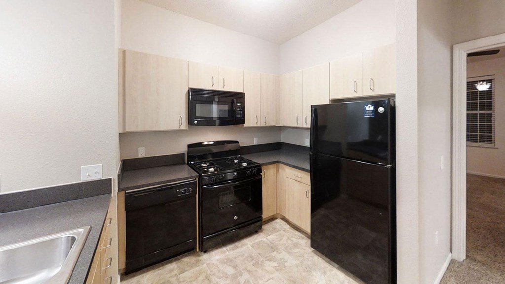 a kitchen with black appliances at Lynbrook Apartment Homes and Townhomes, Elkhorn