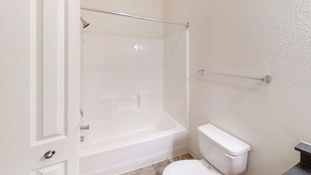 a bathroom with a shower and a toilet at Lynbrook Apartment Homes and Townhomes, Elkhorn
