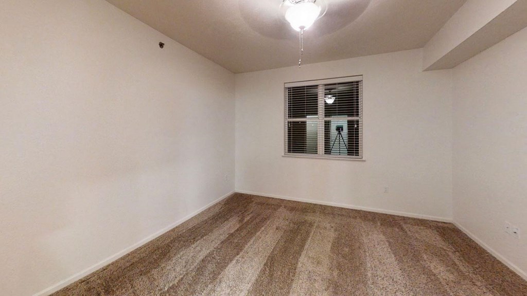 an empty bedroom with white walls and a window at Lynbrook Apartment Homes and Townhomes, Elkhorn