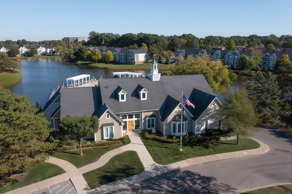 A house with a flag on the front lawn.