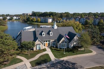 A house with a flag on the front lawn.