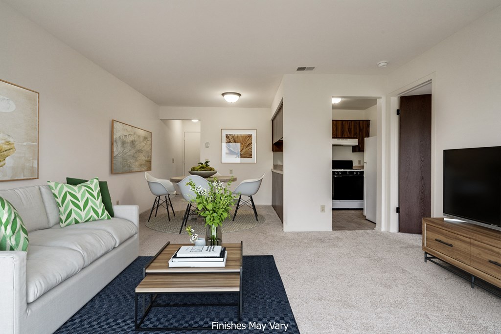 a living room with a couch and a coffee table at The Landings Apartments, Westland, MI, 48185