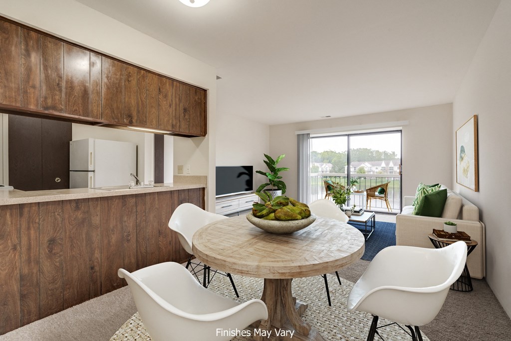 a kitchen and dining area in a 555 waverly unit  at The Landings Apartments, Westland, MI