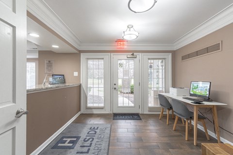a dining room with a table and chairs and a computer on a desk