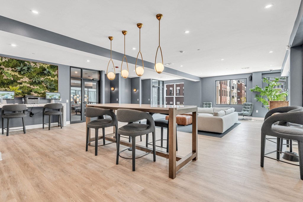 A modern dining room with a wooden table and chairs at Luxe 360 on Centerpointe Apartments, Midlothian, 23114
