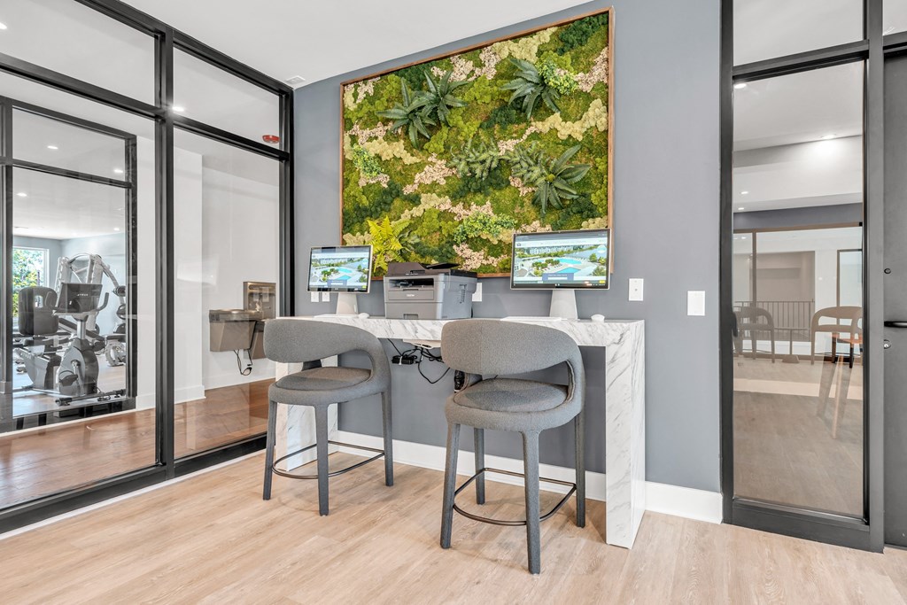 Two grey chairs are placed in front of a desk with a computer at Luxe 360 on Centerpointe Apartments, Midlothian, VA