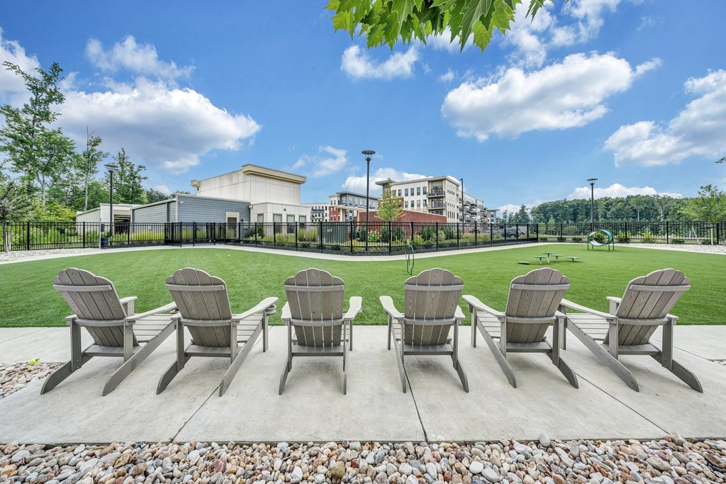A row of chairs are lined up on a patio.