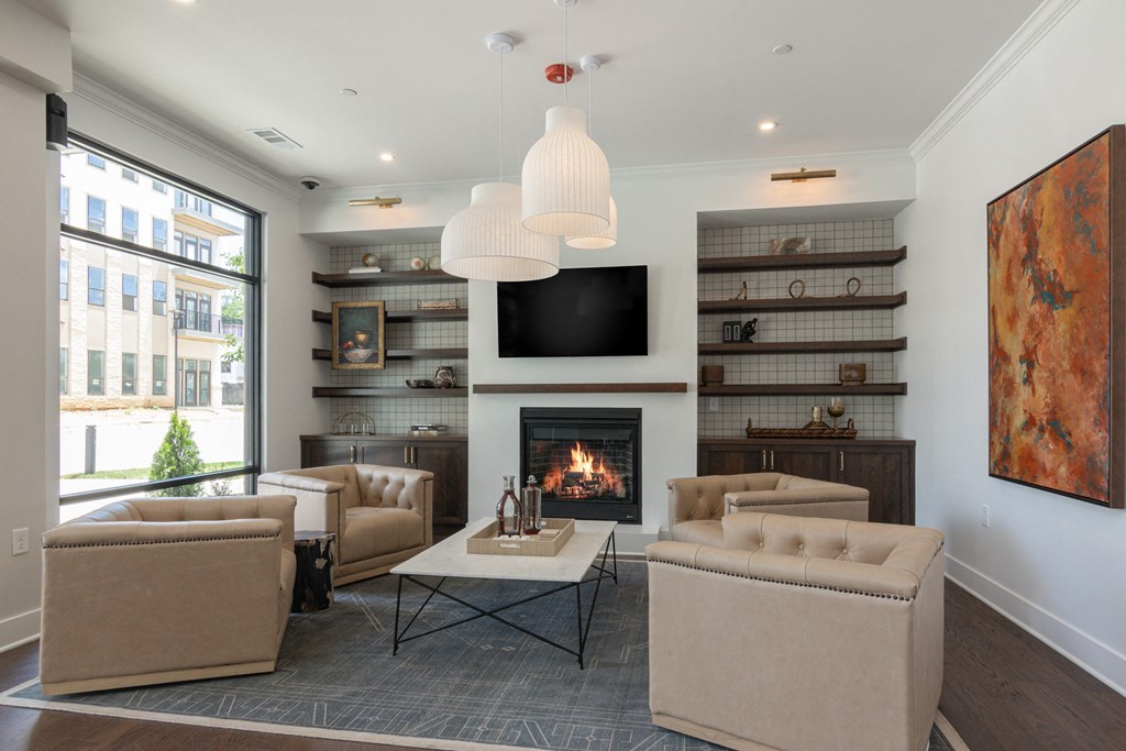 A living room with a fireplace and a television at Luxe 360 on Centerpointe Apartments, Midlothian, Virginia