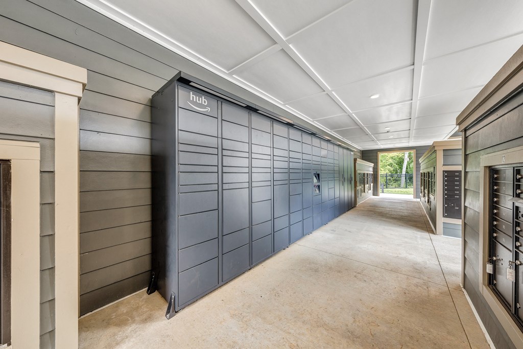A long hallway with a black wall on one side and a white ceiling.