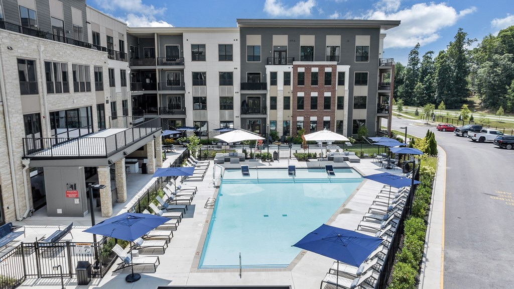 A large building with a pool in front.