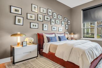 A bedroom with a large bed and a nightstand with a lamp at Luxe 360 on Centerpointe Apartments, Virginia, 23114