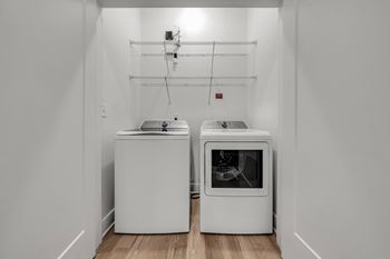 A white kitchen with a dishwasher and an oven at Luxe 360 on Centerpointe Apartments, Midlothian, 23114