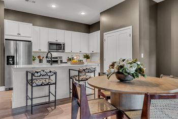 A kitchen with a table and chairs. at Luxe 360 on Centerpointe Apartments, Midlothian, VA, 23114