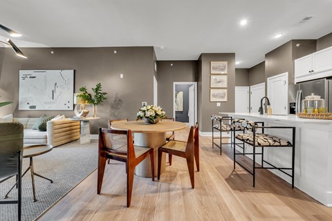 A modern dining room with a wooden table and chairs at Luxe 360 on Centerpointe Apartments, Virginia, 23114