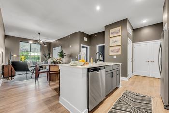 A modern kitchen with a dining table and chairs at Luxe 360 on Centerpointe Apartments, Virginia, 23114