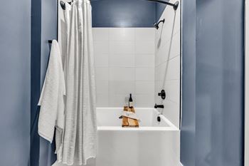 A white bathroom sink with a towel hanging on the wall at Luxe 360 on Centerpointe Apartments, Virginia