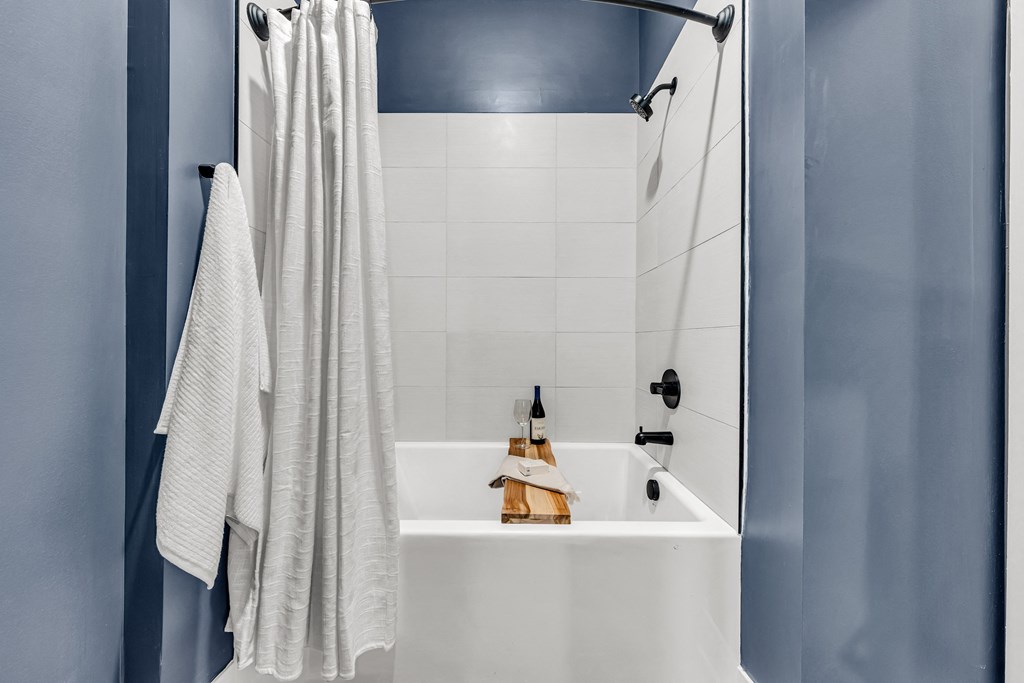 A white bathroom sink with a towel hanging on the wall at Luxe 360 on Centerpointe Apartments, Midlothian, 23114