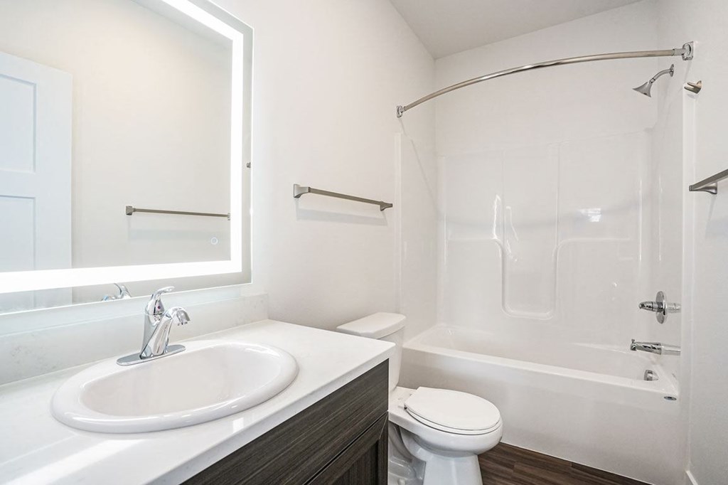 a bathroom with a sink toilet and bathtub at Meadowbrooke Apartment Homes, Grand Rapids, Michigan