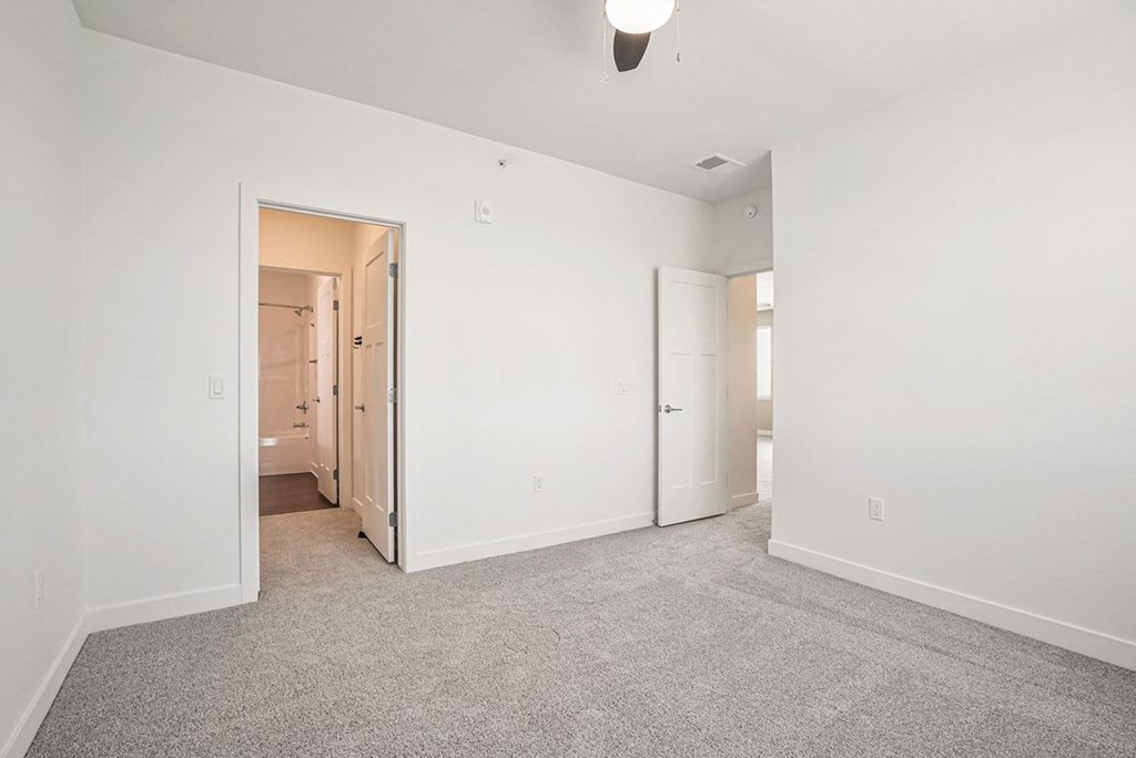 a bedroom with white walls and carpet at Meadowbrooke Apartment Homes, Grand Rapids, MI