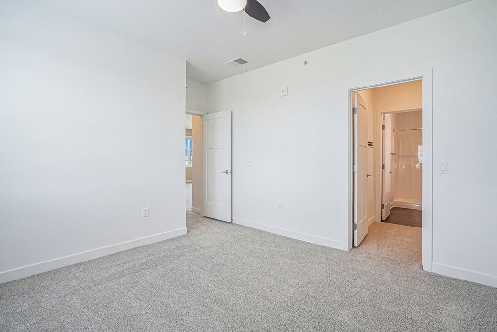 a bedroom with white walls and carpet at Meadowbrooke Apartment Homes, Grand Rapids