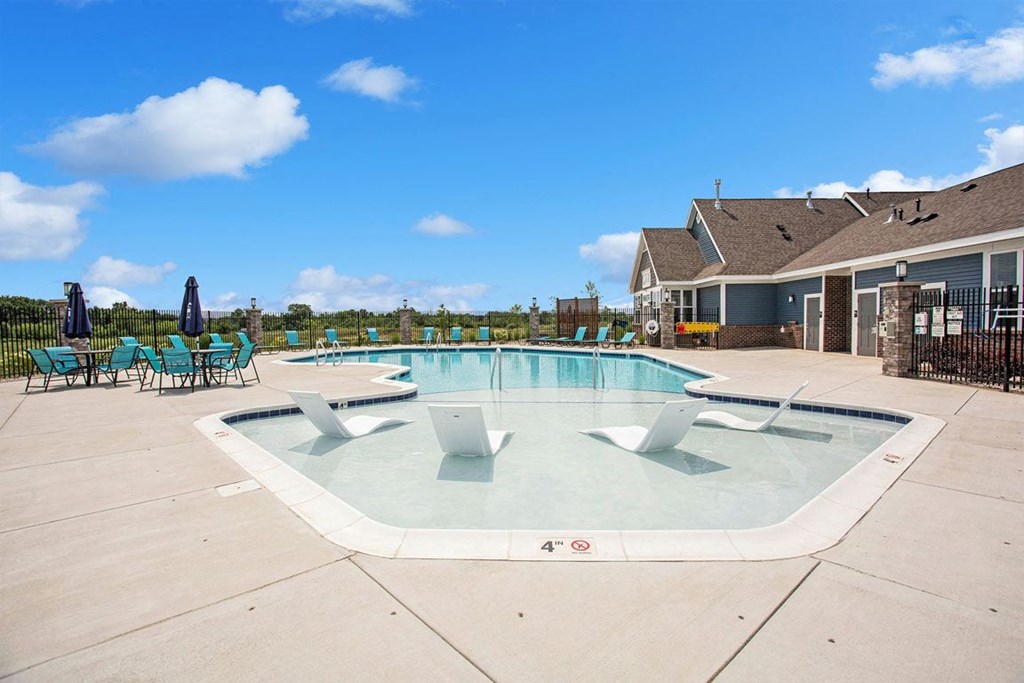 our apartments showcase an outdoor pool at Meadowbrooke Apartment Homes, Michigan
