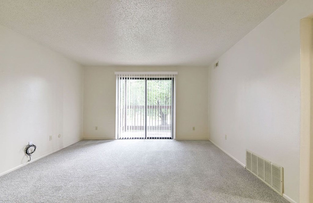 Living Room to Private Balcony at Old Monterey Apartments in Springfield, MO