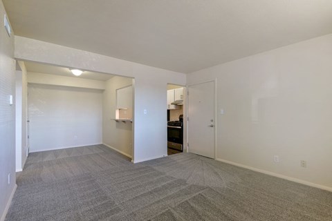 A spacious dining room with a carpeted floor and a breakfast bar at Old Monterey Apartments in Springfield, MO