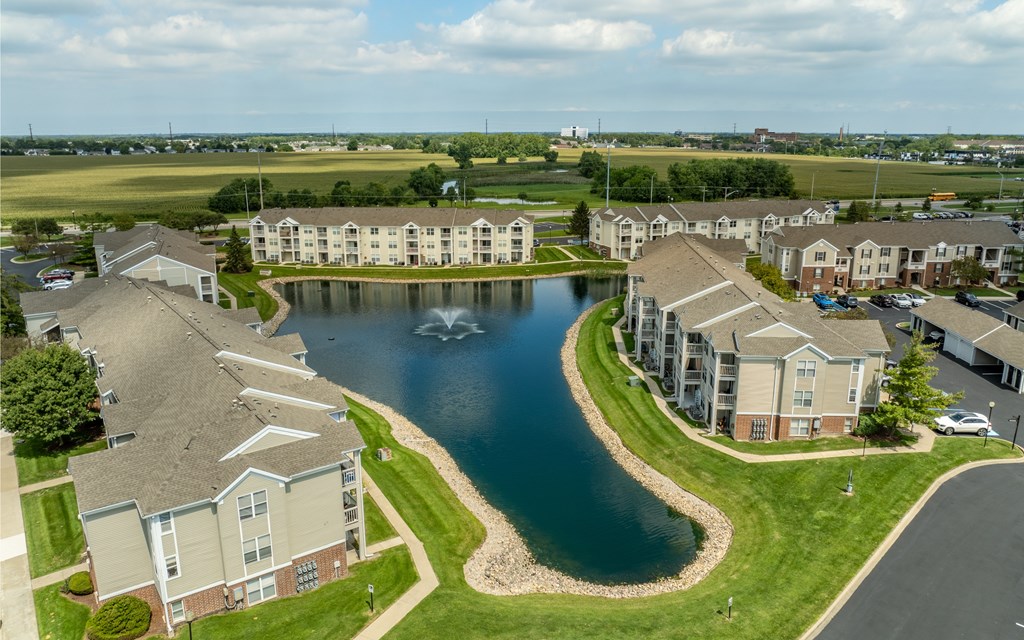 A large building complex with a lake in the middle at Mallard Bay Apartments, Crown Point, Indiana