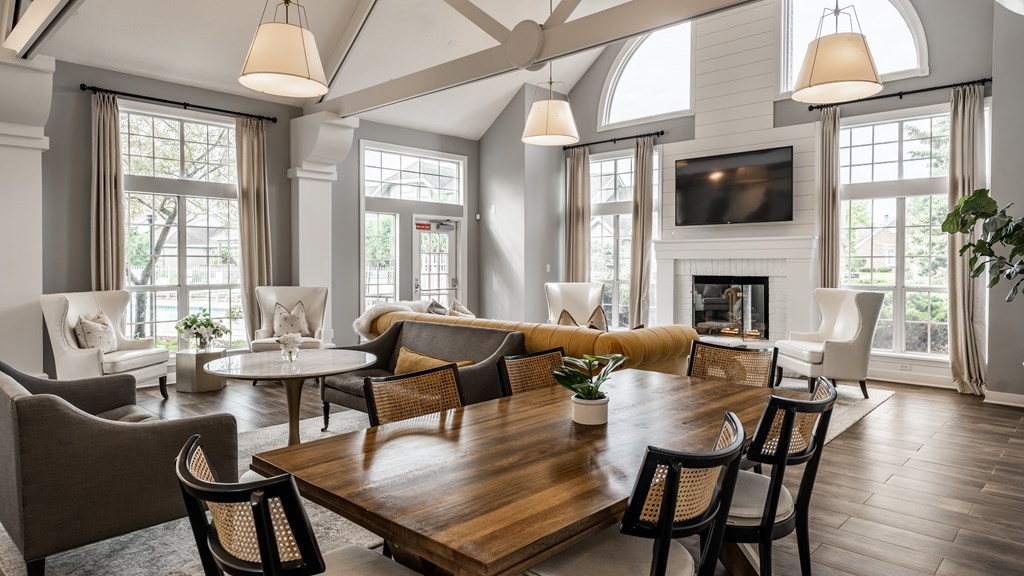 A large, well-lit living room with a wooden table and chairs at Mallard Bay Apartments, Crown Point, Indiana