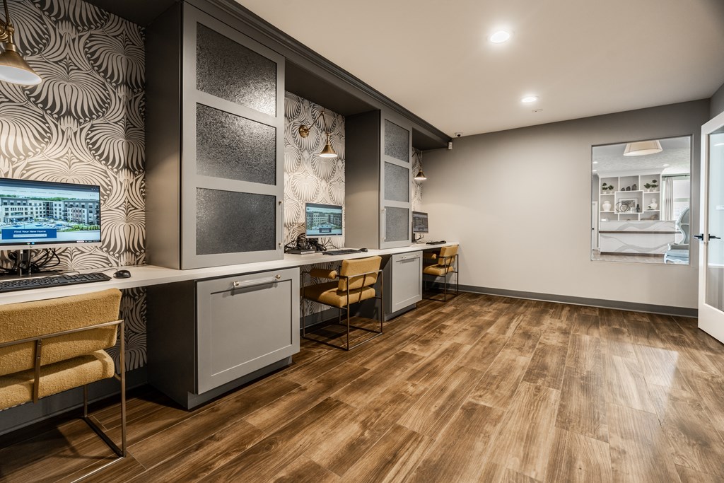A modern kitchen with wooden floors and a patterned wallpaper at Mallard Bay Apartments, Crown Point, Indiana