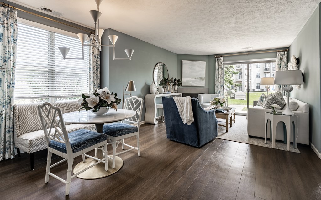 A living room with a white chair set and a blue sofa at Mallard Bay Apartments, Crown Point, Indiana