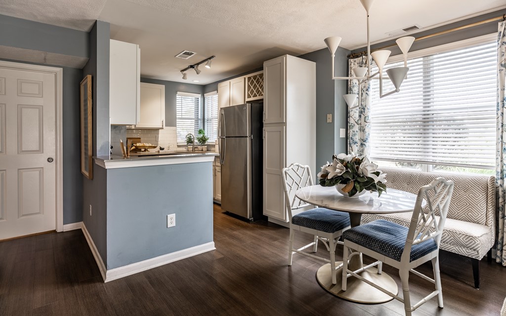 A kitchen with a table and chairs in front of a window at Mallard Bay Apartments, Crown Point, Indiana