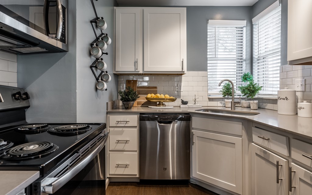 A modern kitchen with a stove, sink, and cabinets at Mallard Bay Apartments, Crown Point, Indiana