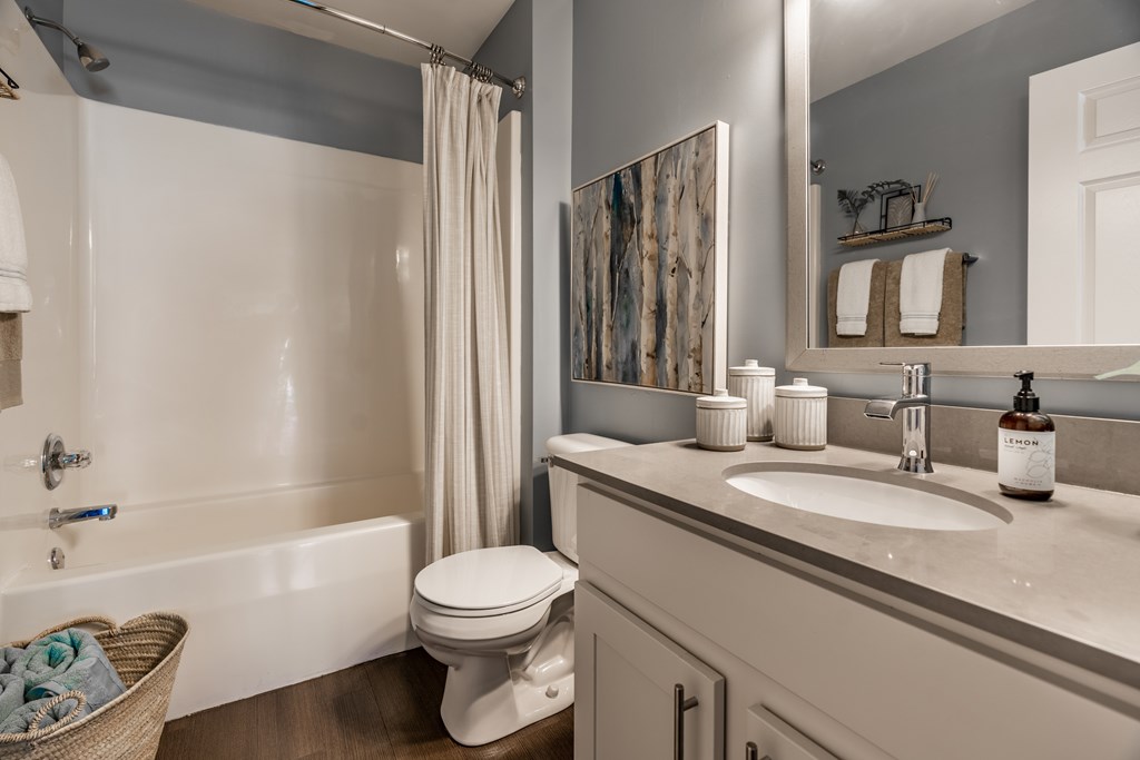 A bathroom with a white toilet, sink, and bathtub at Mallard Bay Apartments, Crown Point, Indiana