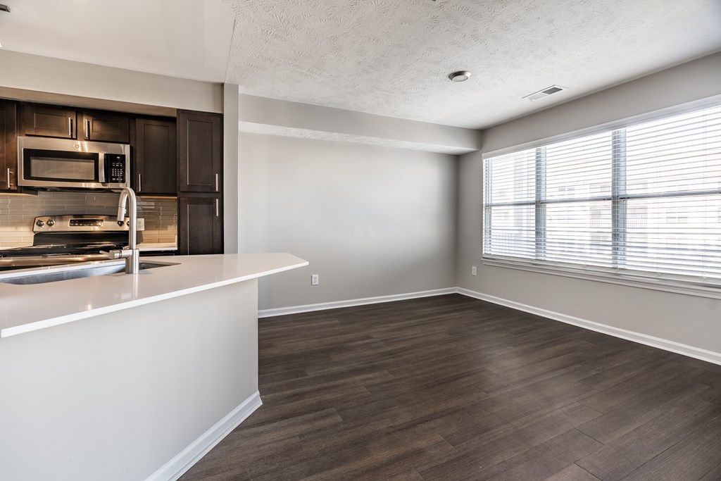 A kitchen with a white countertop and wooden flooring at Mallard Bay Apartments, Crown Point, Indiana
