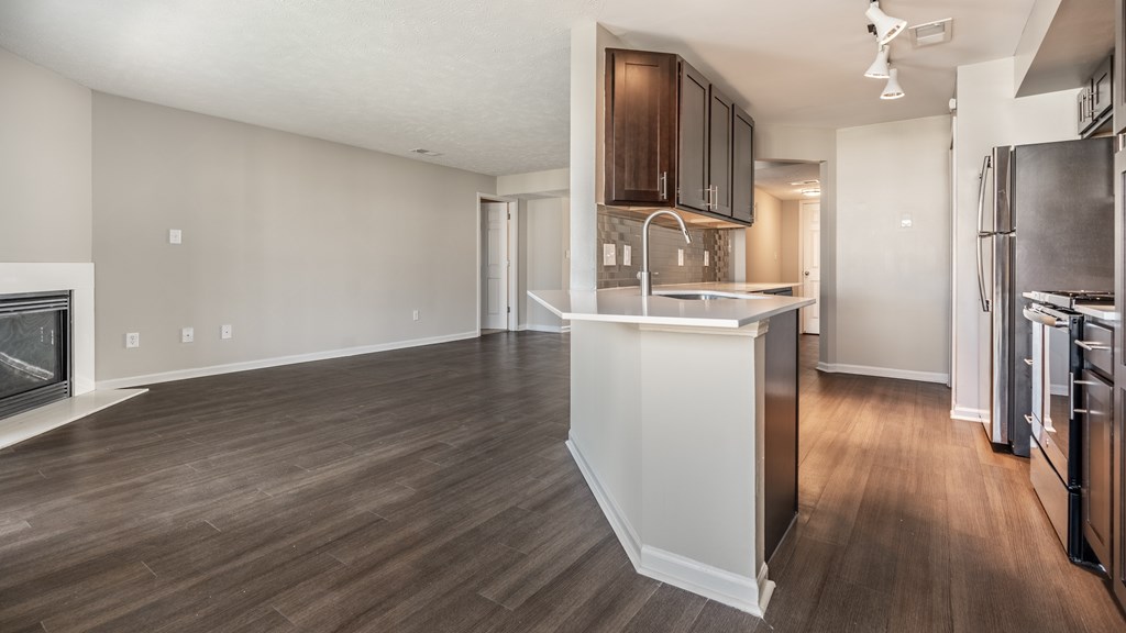 A kitchen with a refrigerator, sink, and cabinets at Mallard Bay Apartments, Crown Point, Indiana