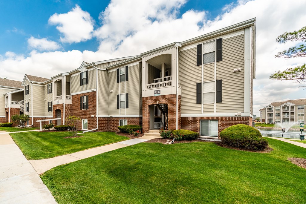 Apartment complex with a grassy front yard and a clear sky at Mallard Bay Apartments, Crown Point, Indiana
