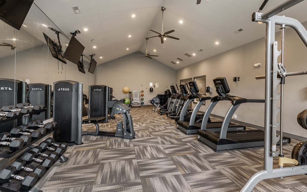 A gym with treadmills, weights, and exercise equipment at Mallard Bay Apartments, Crown Point, Indiana