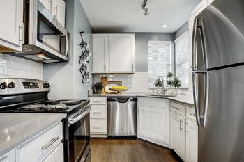 A modern kitchen with white cabinets and stainless steel appliances at Mallard Bay Apartments, Crown Point, 46307