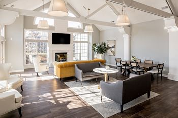 A living room with a fireplace and a TV on the wall at Mallard Bay Apartments, Crown Point