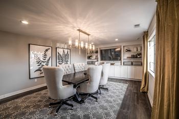 A dining room with a table and chairs at Mallard Bay Apartments, Crown Point, IN