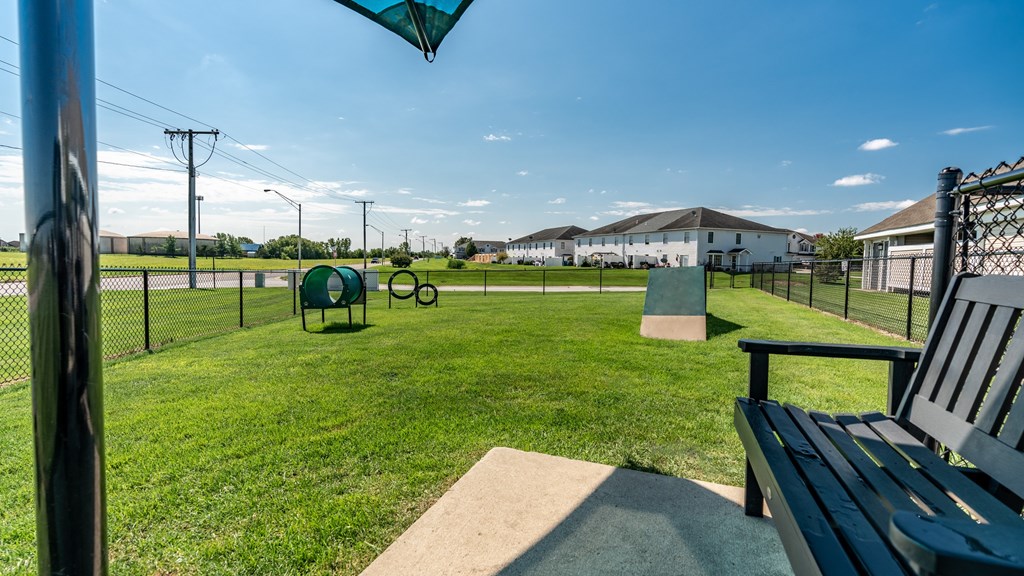 A park with a bench and a fence at Mallard Bay Apartments, Crown Point, Indiana