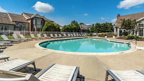 A large outdoor swimming pool surrounded by sun loungers at Mallard Bay Apartments, Crown Point, Indiana