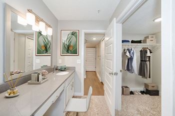 a bathroom with a large mirror and a walk in closet at WaterFront Apartments, Virginia, 23453