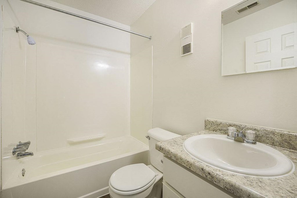 an upgraded bathroom with white cabinets at Newport Village Apartments, Portage, MI