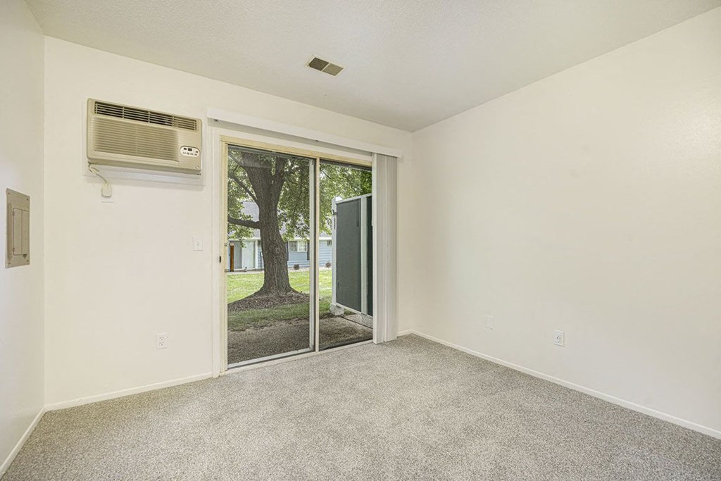 Slider to a semi private patio at Newport Village Apartments, Portage, MI