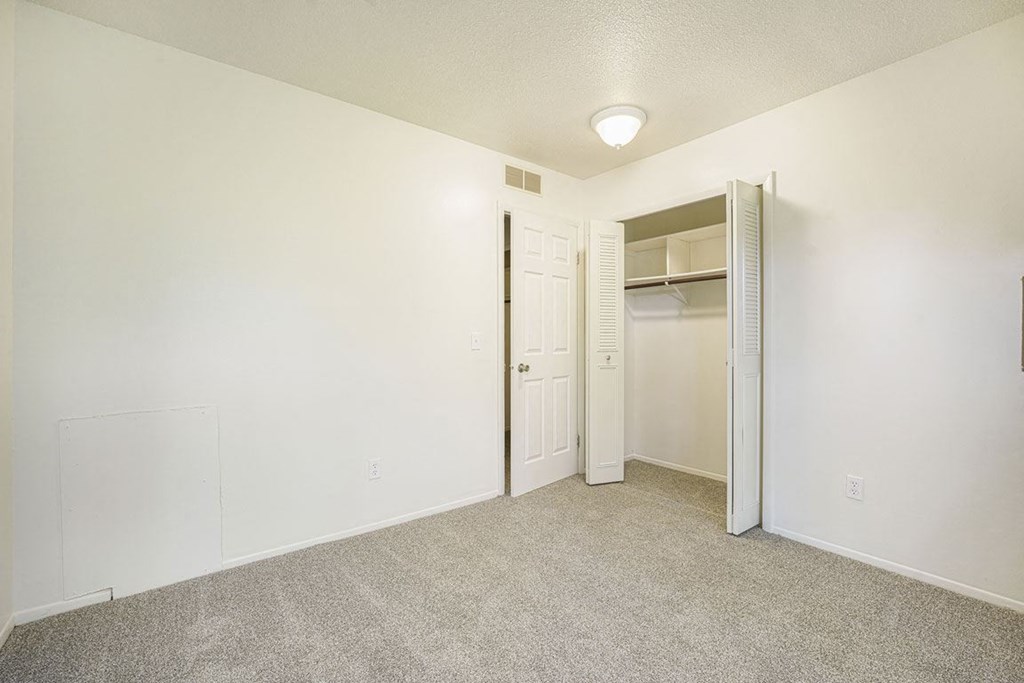 a bedroom with a large closet at Newport Village Apartments, Portage, MI